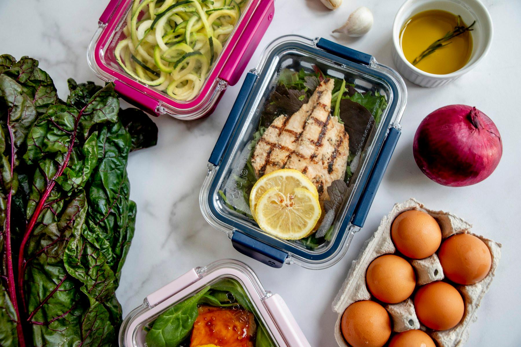 Prepared meals and fresh ingredients arranged in containers